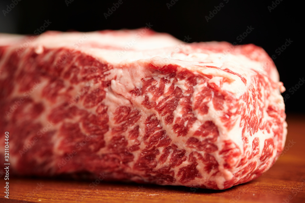 Fresh raw steak beef on black background Fresh raw steak beef on black background