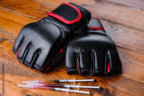 mma gloves and steroid medication composition on a wooden background