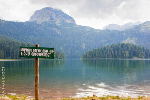 Durmitor national Park in Montenegro. Warning sign on Black lake