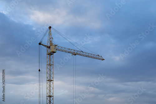 Tower Crane in the clouds and blue sky.