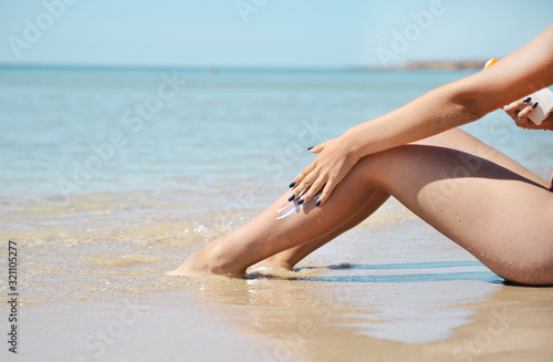 Female legs on the beach.
