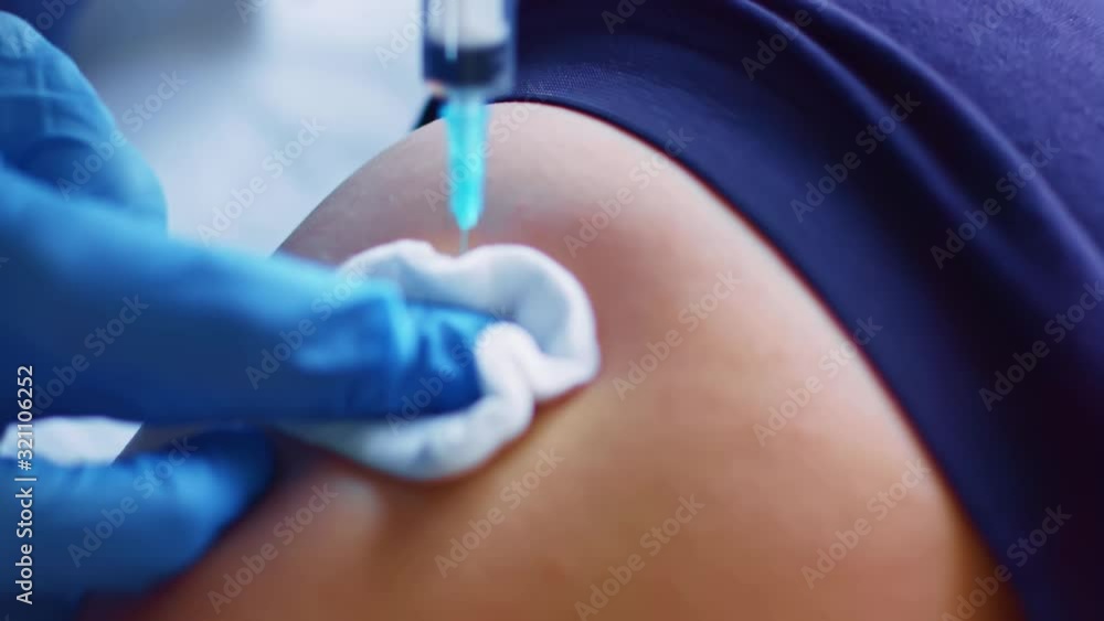 Syringe needle injects intramuscular vaccine Syringe needle injects intramuscular vaccine