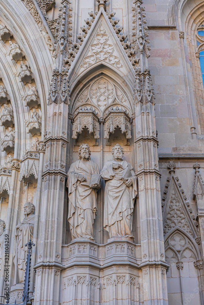 Facade elements with apostles of the Gothic Barcelona Cathedral, Basilica La Catedral de la Santa Creu i Santa Eulalia in Gothic Quarter. Barcelona, Spain.