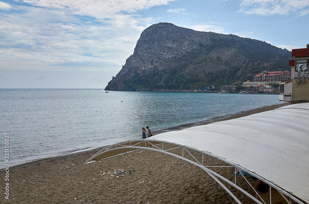New World, Republic of Crimea - June 1, 2017: Black Sea coast, sandy beach with mountain views.