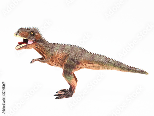Tyrannosaur rubber toy isolated on white © Y