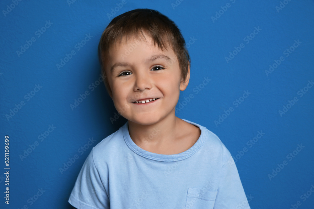 Portrait of happy little boy on blue background Portrait of happy little boy on blue background