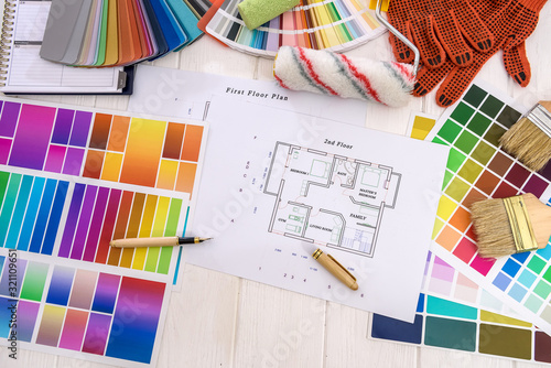 Top view of house plan and colorful swatches on wooden table