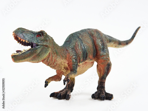 Tyrannosaur rubber toy isolated on white © Y