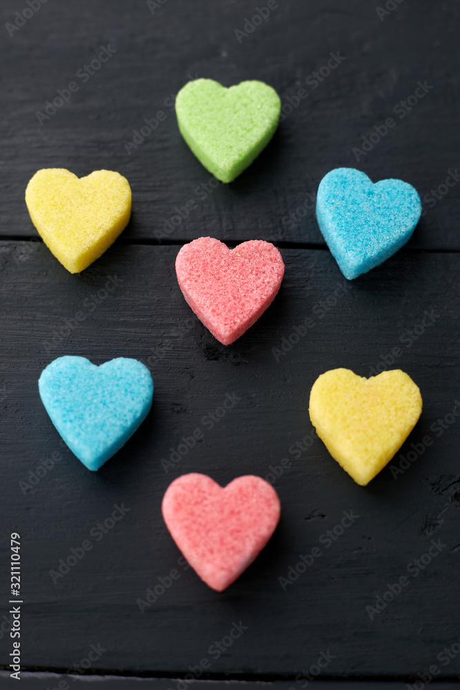 Colorful sugar hearts on dark wooden background. Valentines Day concept.