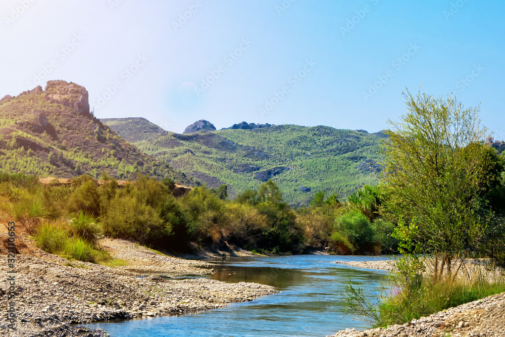 a river in the mountains on a sunny day