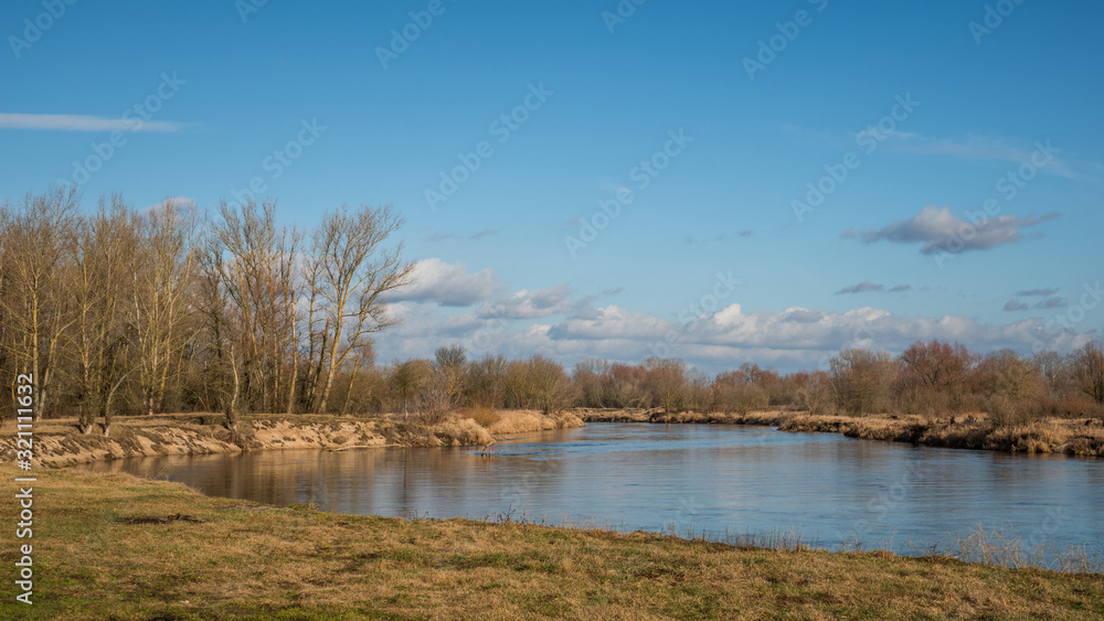 Pilica river at sunny day and blue sky near Mniszew, Poland