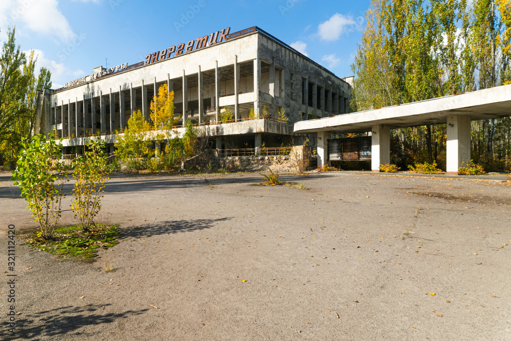 Abandoned amd contaminated palace of culture Energetic building in Pripyat in 2019 with colorful autumn nature around.Blank space image. No person.