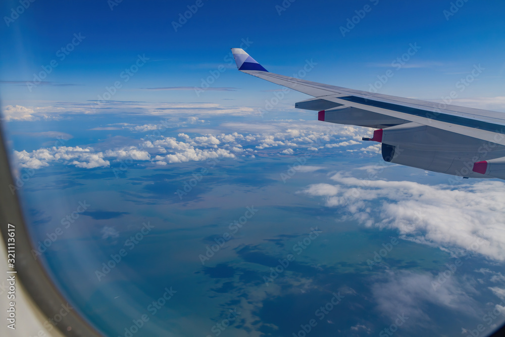 Obraz premium Sunny aerial sky landscape from and airplane window seat