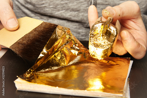 Artwork of gilding - covering an object with plate metal gold