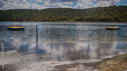 Laguna en calma con dos plataformas flotantes amarillas photo