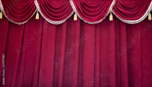 Heavy, dense burgundy theater curtain in the theater, philharmonic