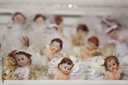 Small toys angels (girls and boys) decorated with beads, feathers and pearls
