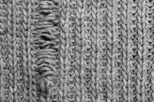 Fotografie Light grey knitting texture with manufacturing defect isolated on white