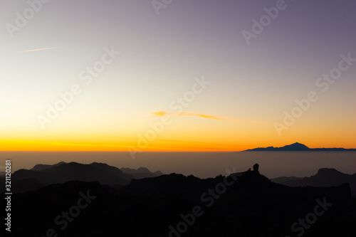 Gorgeous sunset with Teide and Roque Nublo mountains silhouettes in Gran Canaria. Bright twilight at tourist attraction destination in Canary Islands  Spain