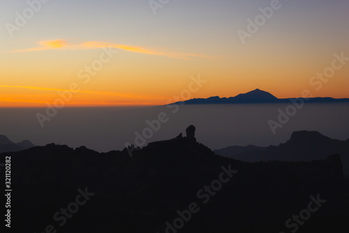 Iconic Roque Nublo and Teide mountains view from Pico de las Nieves in Canary Islands  Spain. Fantasy sunset in Gran Canaria. Tourism attraction viewpoint  summer destination concepts