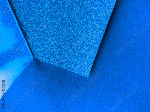 Paper background with paper texture in different blue tones Light blue with deep blue. Geometric sheets of paper.