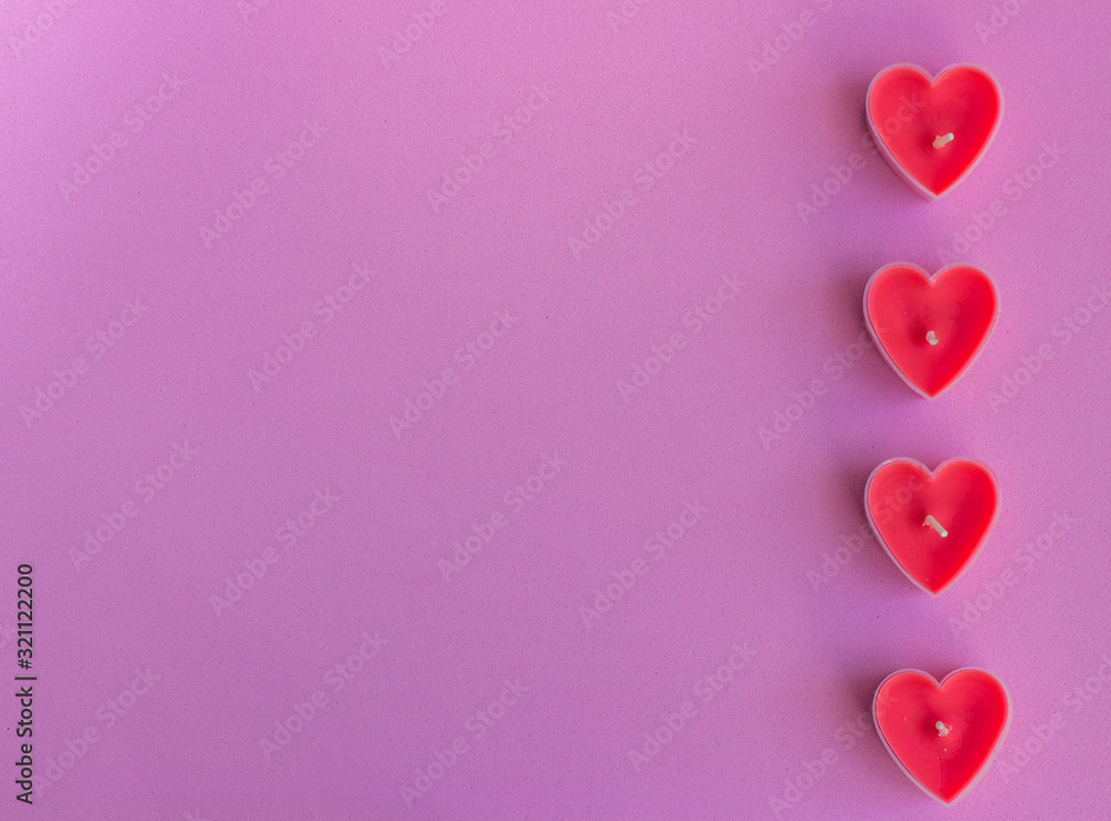 Hearts on the pink background. Candles in the shape of hearts. Happy Valentines Day. 14 February, women's day, March 8. Top view. Flat lay. Greeting card. Copy space for text.