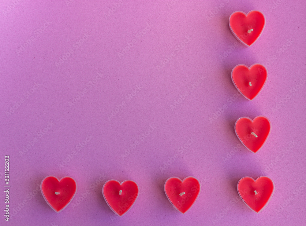 Hearts on the pink background. Candles in the shape of hearts. Happy Valentines Day. 14 February, women's day, March 8. Top view. Flat lay. Greeting card. Copy space for text.