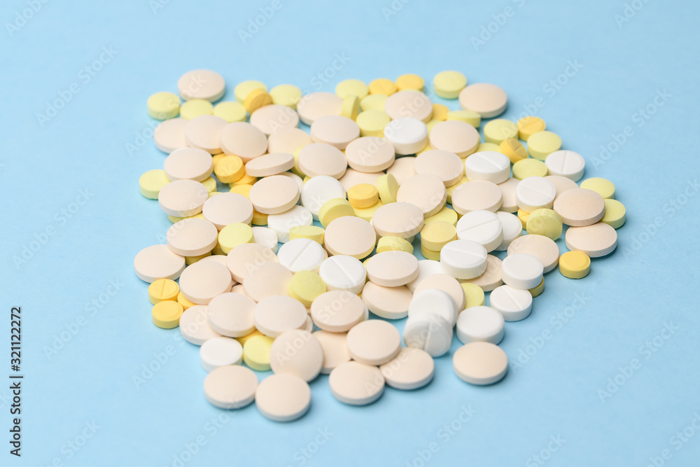 yellow and white tablets on a blue background close up