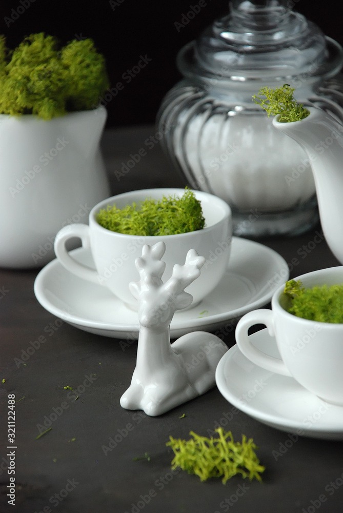 Magical tea party. Kettle and cups with moss. Magical tea party. Kettle and cups with moss.
