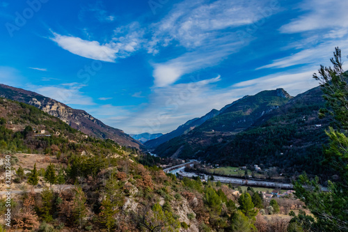 The captivating panoramic view of the low Alps mountains and the river Var in the French Alpes-Maritimes department