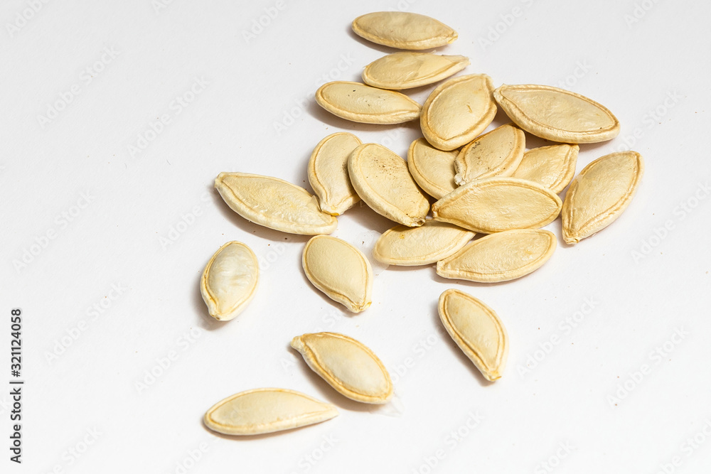 Pumpkin seeds or pepitas, isolated on white background. Top view. Flat lay Pumpkin seeds or pepitas, isolated on white background. Top view. Flat lay