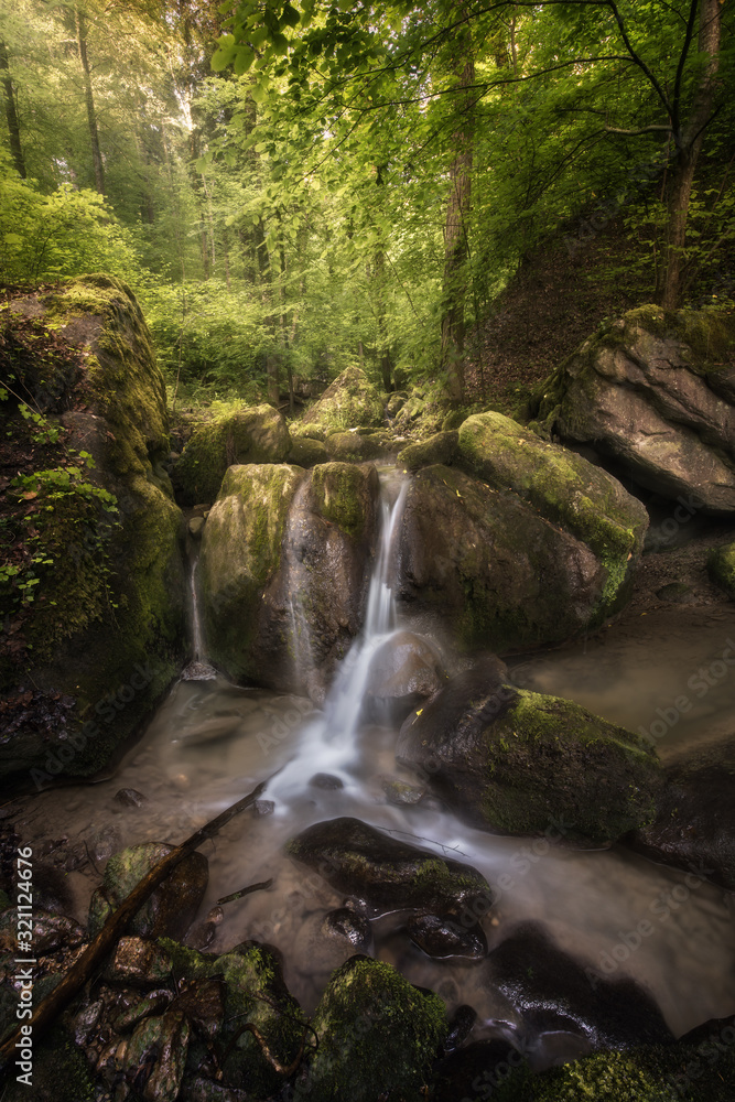 Golden light over a small waterfall Golden light over a small waterfall