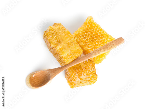 Fresh delicious honeycombs and spoon isolated on white, top view