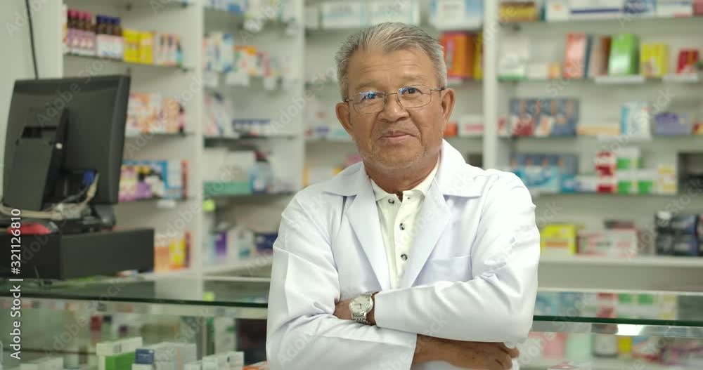 Closeup portrait of a asian senior pharmacist looking at camera in drugstore. Closeup portrait of a asian senior pharmacist looking at camera in drugstore.