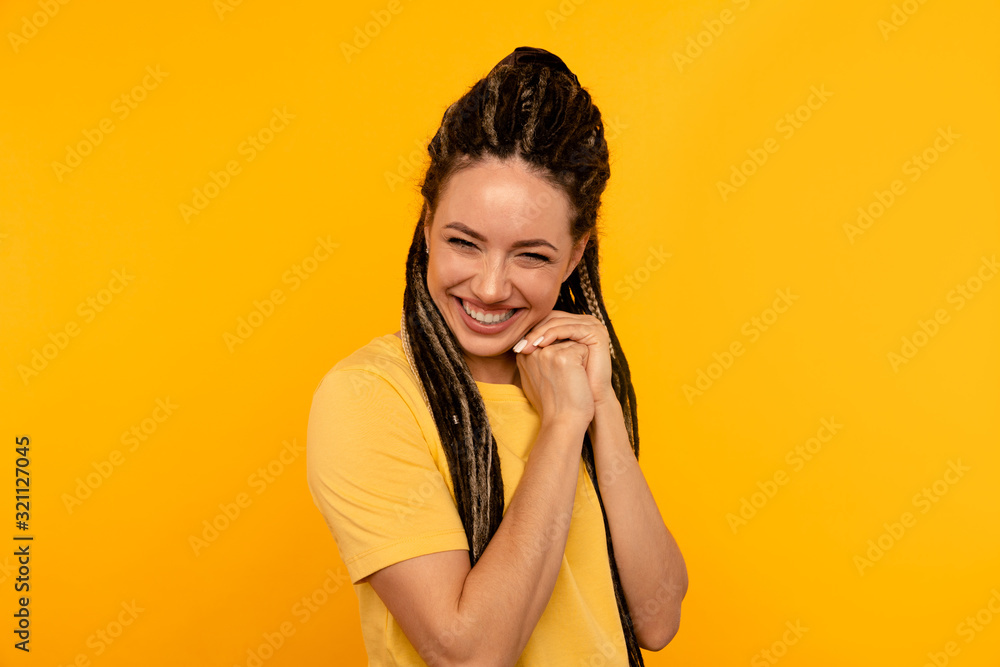 Fototapeta premium Glad pleased happy young woman in the yellow studio