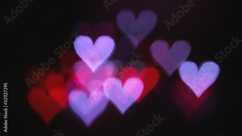 Colorful bokeh on a black background, in the form of heart