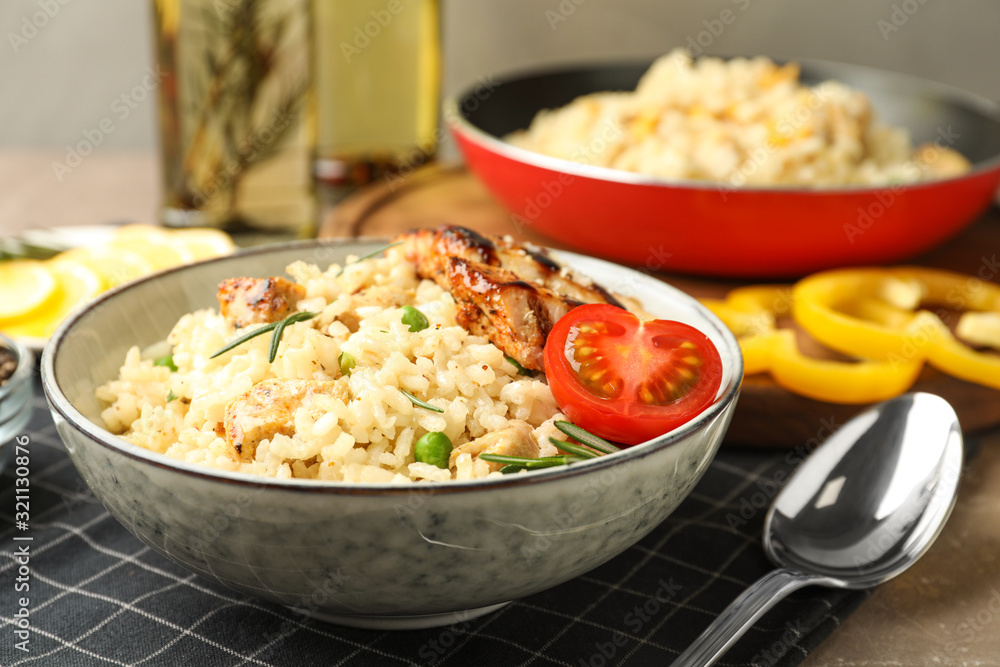 Delicious chicken risotto with tomato on table, closeup Delicious chicken risotto with tomato on table, closeup