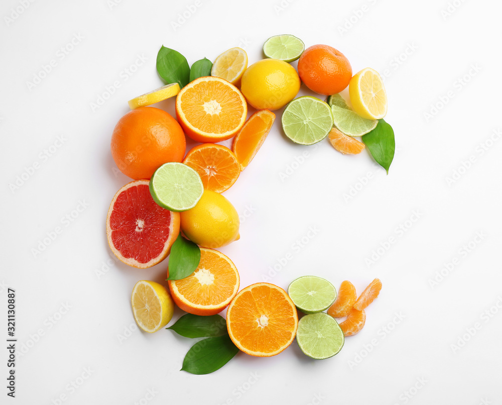 Letter C made with citrus fruits on white background as vitamin representation, top view Letter C made with citrus fruits on white background as vitamin representation, top view