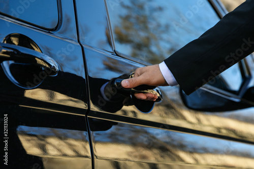 Valokuva Driver opening door of luxury car, closeup. Chauffeur service