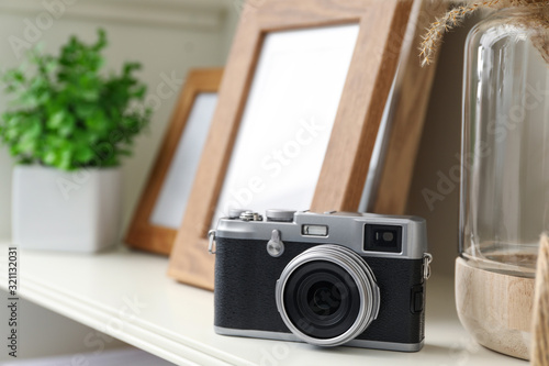 White shelving unit with retro camera and photo frames