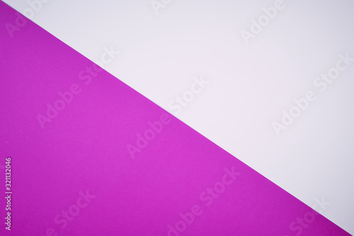 diagonal laid colored paper in magenta and white as background photo, copyspace