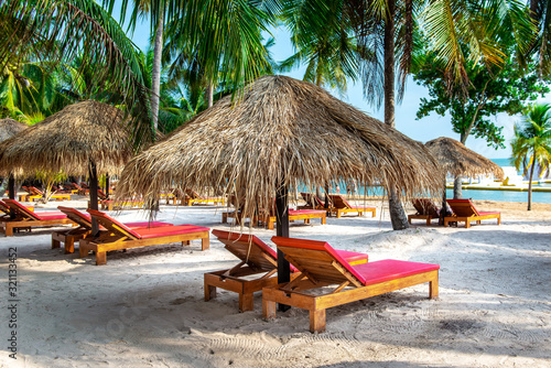 Rest area with sunbeds and umbrellas near the beach on the island