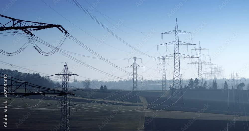 Drone shot of electricity pylons in agricultural field against sky, Baden-Wuerttemberg, Germany