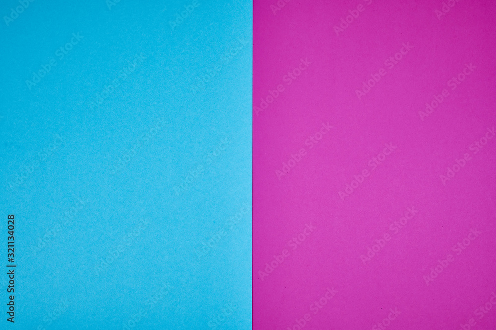 Fototapeta premium blue and magenta colored papers laid together as background photo with copy space