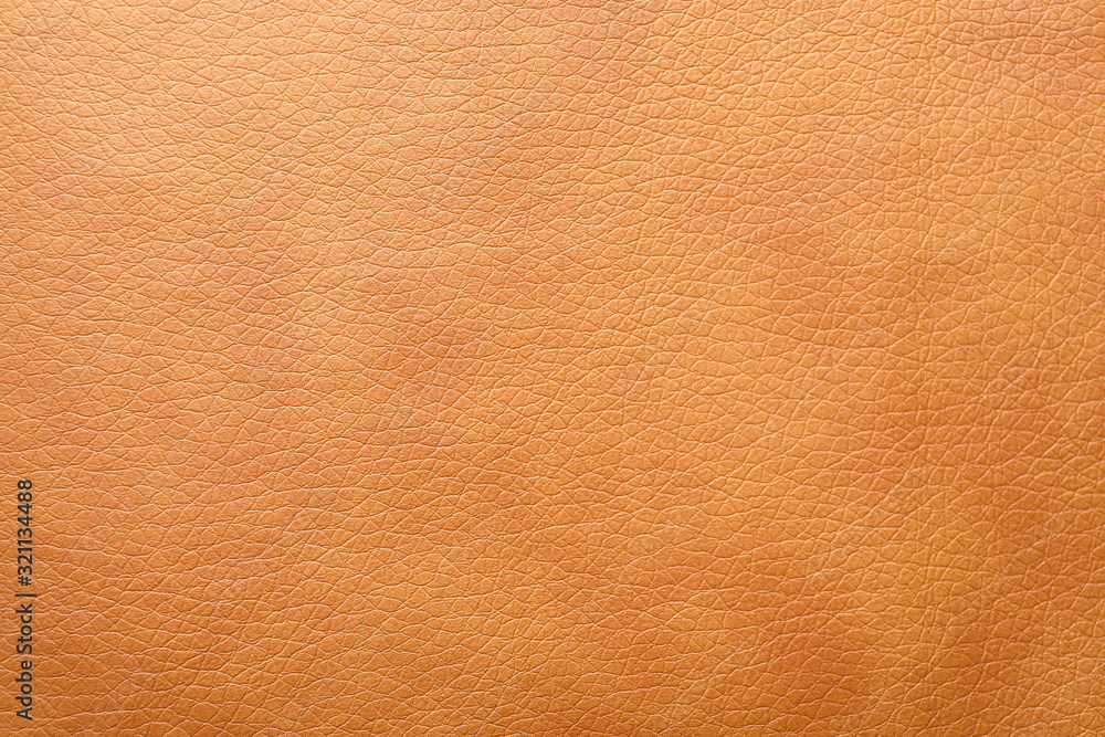 Fototapeta premium Texture of orange leather as background, closeup