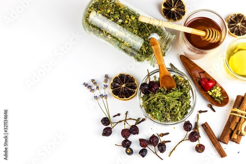 Medicinal herbal tea with honey on white background. Traditional treatment of flu and cold. Alternative medicine. Medicinal herbs.