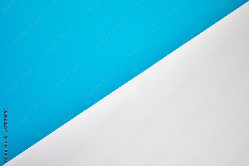 diagonal laid colored paper in blue and white as background photo with copyspace