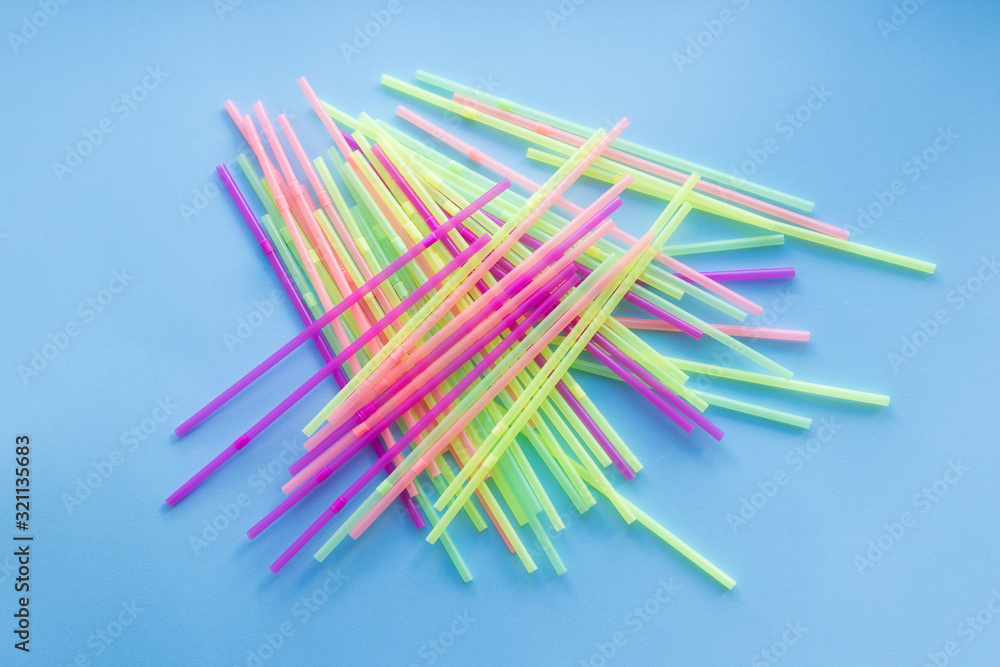 Colored plastic drinking straws on a blue background Colored plastic drinking straws on a blue background