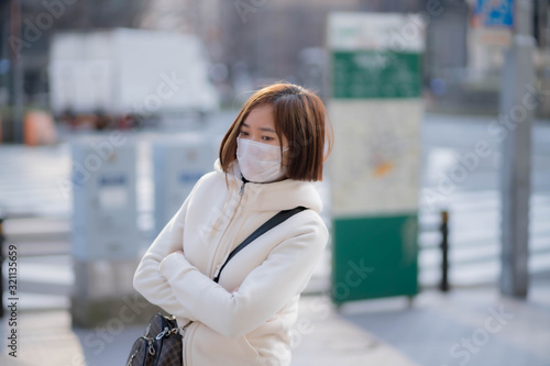 屋外でマスクをしている若い女性