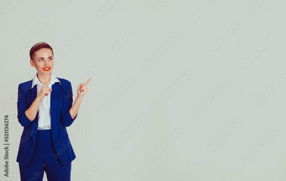 Businesswoman gesturing at right copy space isolated light green white office wall background. Short hair, red lips, blue suit, white shirt formal wear Businesswoman gesturing at right copy space isolated light green white office wall background. Short hair, red lips, blue suit, white shirt formal wear